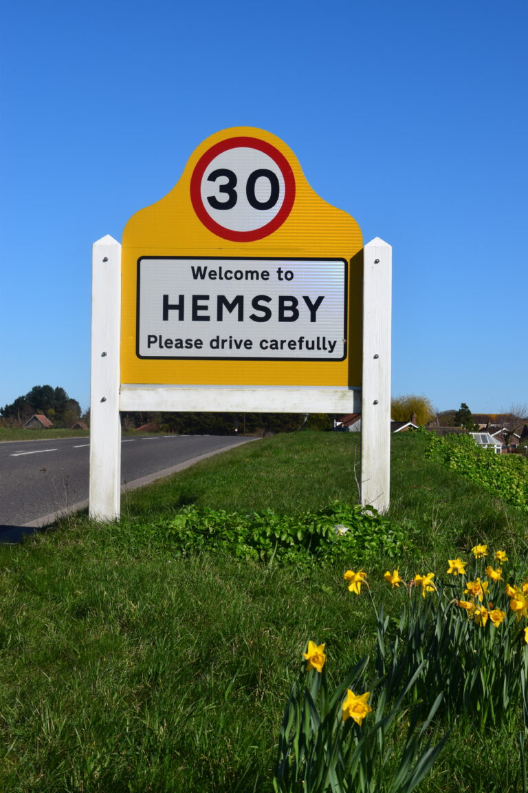 Hemsby sign with daffodils